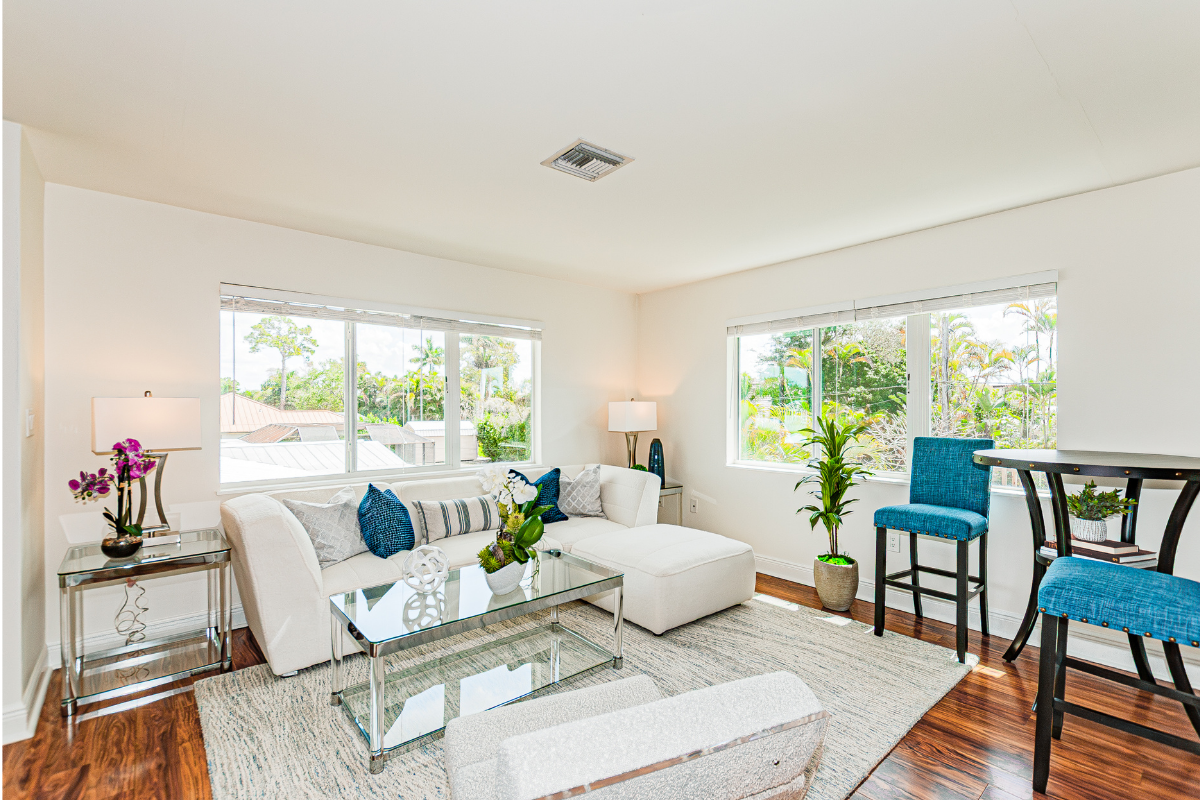 Staged loft lounge in Naples Park home with light furniture and relaxed seating area by Naples Home Staging